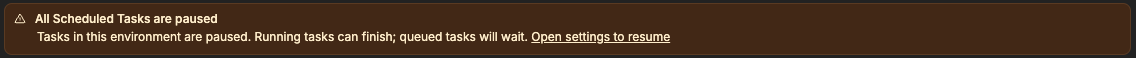 Banner saying All Scheduled Tasks are paused, with a link to open settings to resume